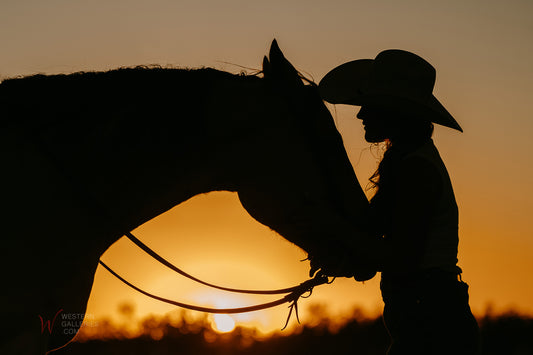 Silhouetted cowgirl and her horse a loving relationship and bond photography by Gillean Dangelmayr | Available at Western Galleries online art gallery of Fredericksburg TX